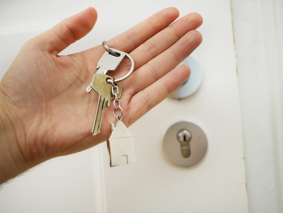 a real estate agent holding a set of housekeys