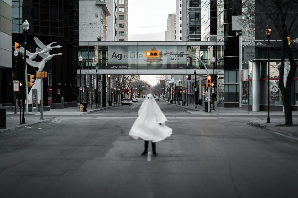 a ghost standing in a road in a city