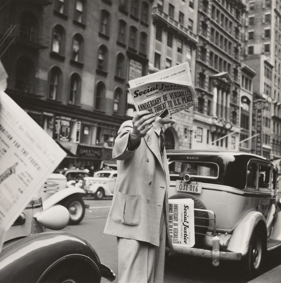 a man holding a newspaper