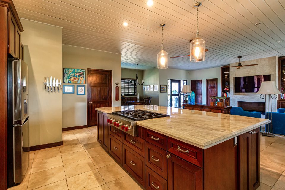 a large open plan kitchen lounge area with an island