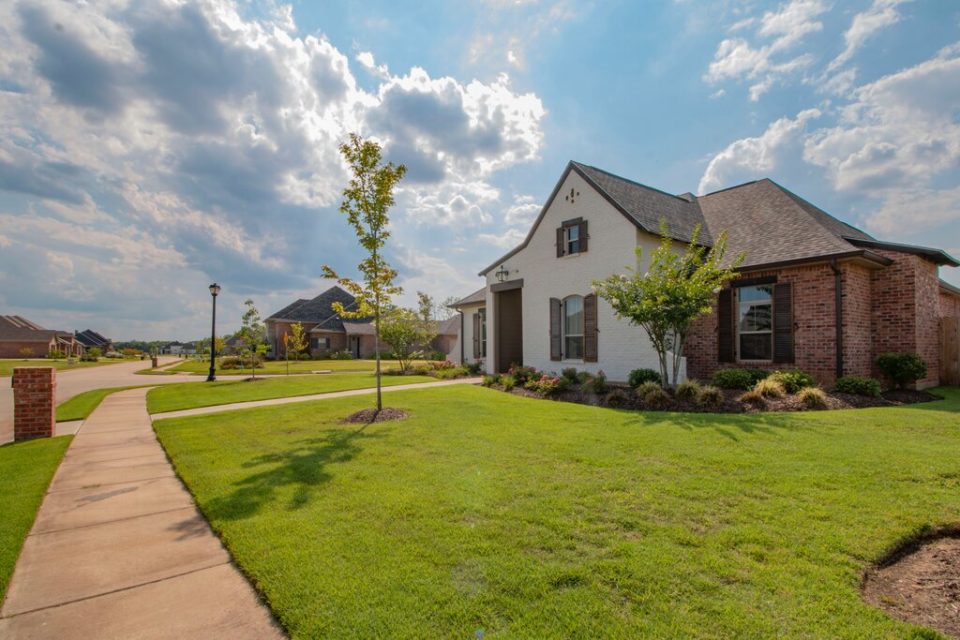 a large property with a grass front lawn