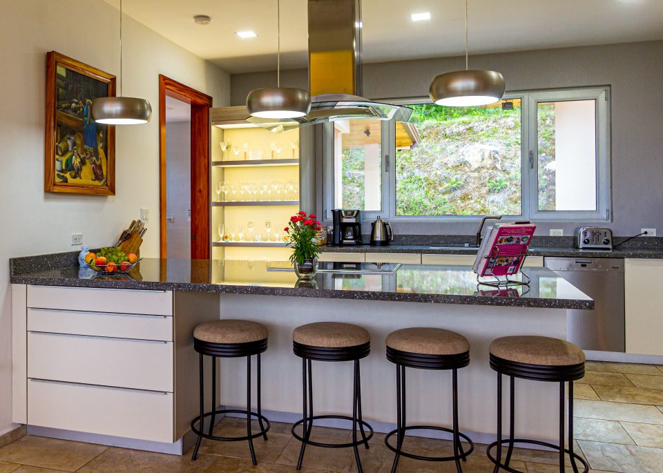 a modern kitchen with an island and bar stools