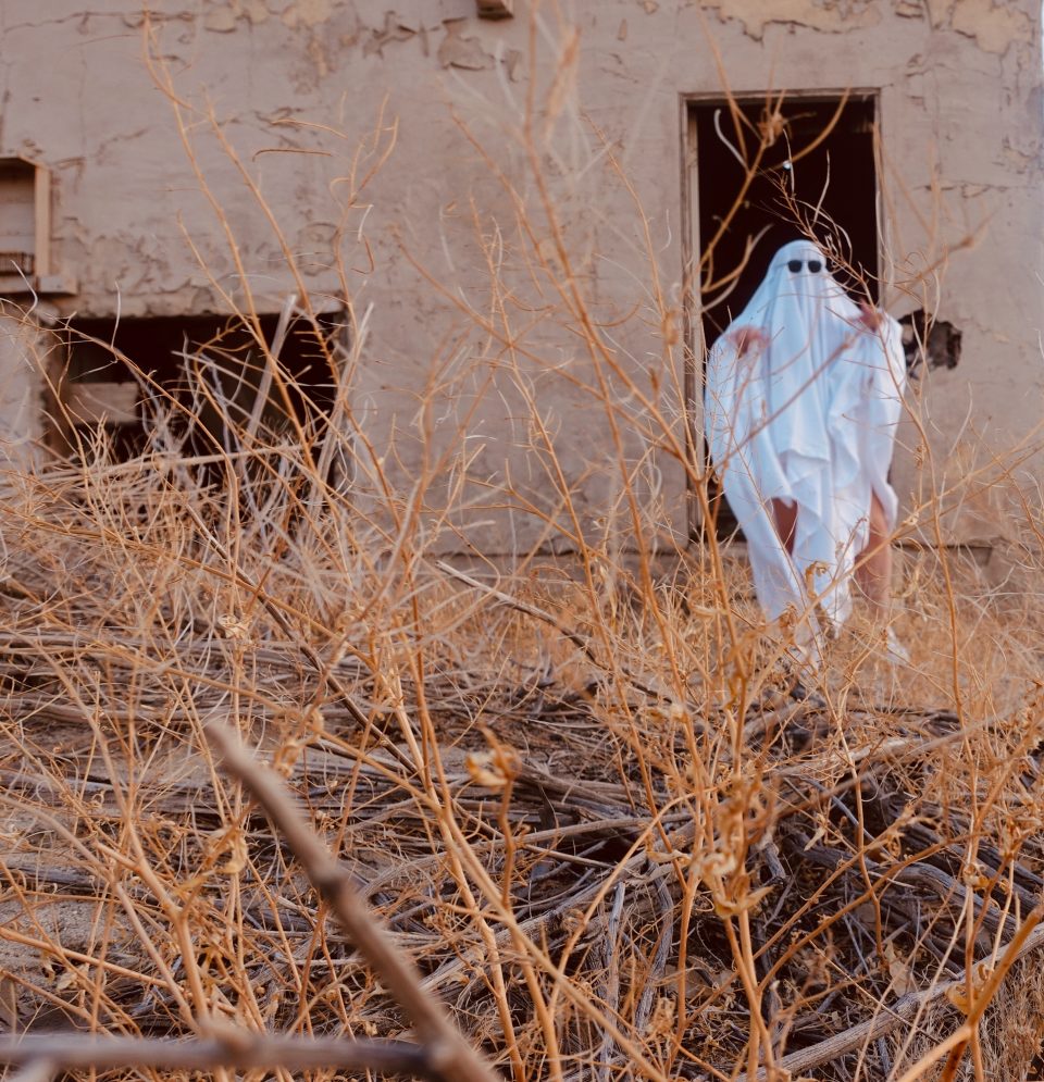 a ghost on the grounds of a haunted house