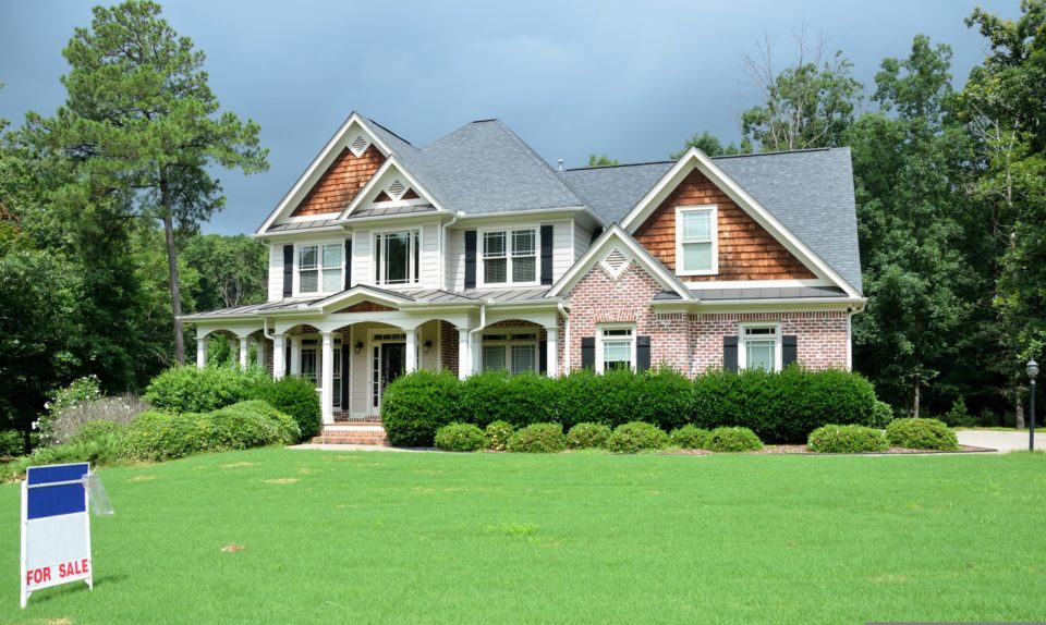 a large house with front lawn for sale