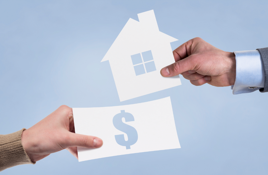 people holding models of a house and dollar bill