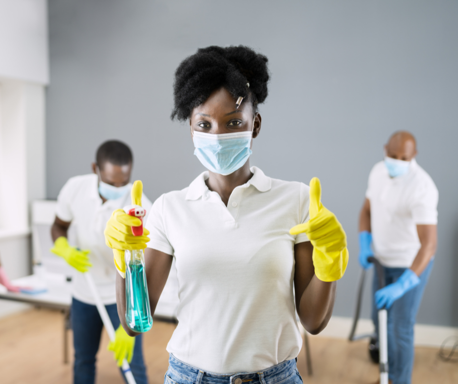 a cleaning team wearing latex gloves and a woman giving thumbs up