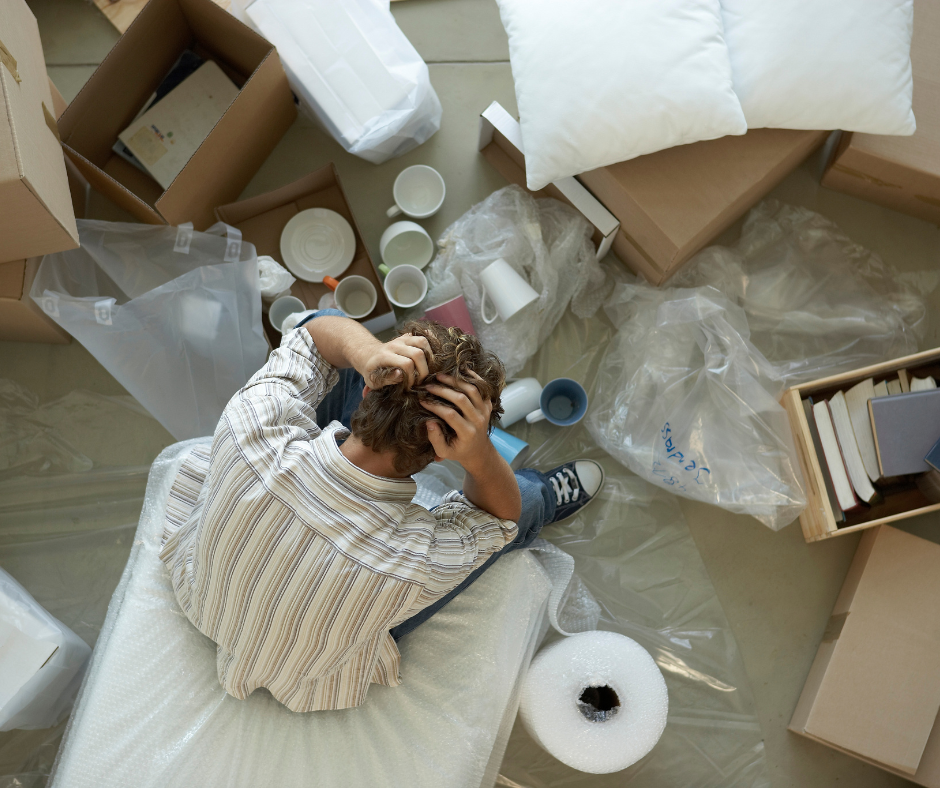 a man overwhelmed when packing property possessions