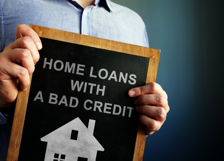 a person holding a sign about home loans with bad credit