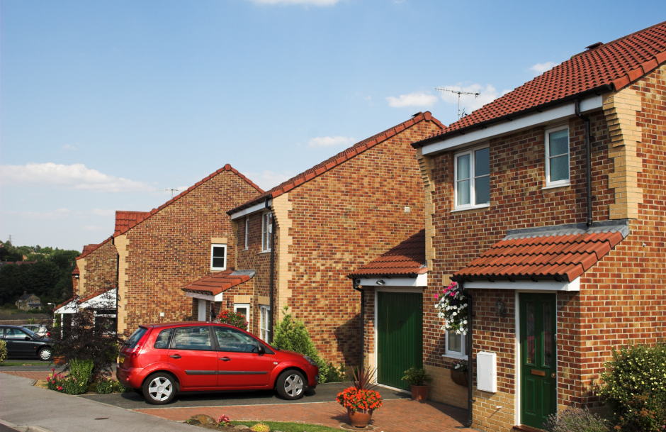 a bricked house with driveway