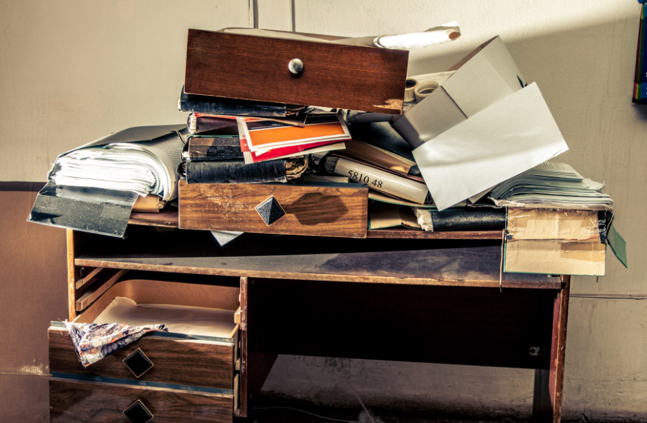 a cluttered desk in a hoarder house