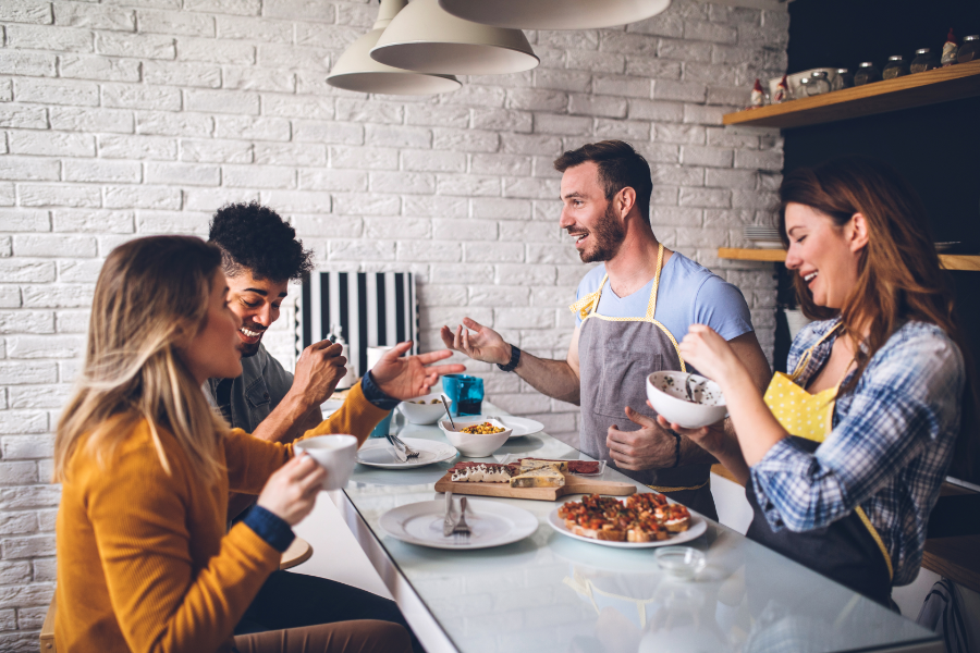 millennial roommates eating in a rental apartment kitchen