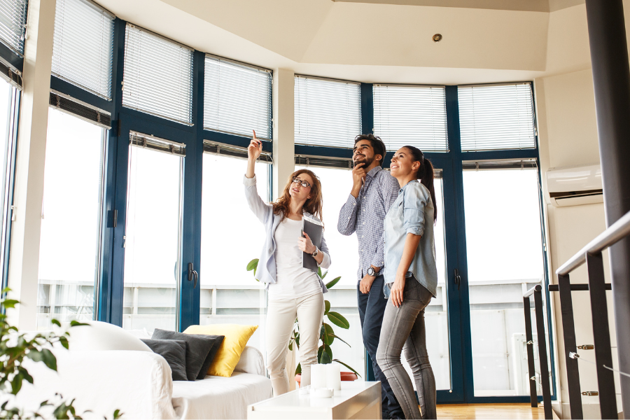 a real estate agent showing a couple around a property