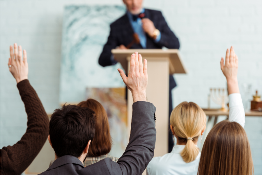 a person raising a hand at a property auction