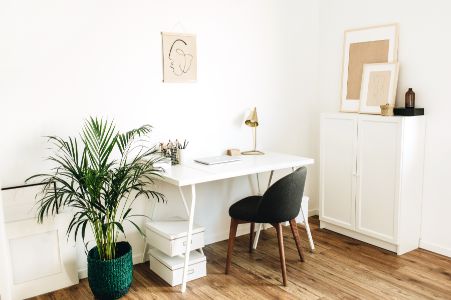 a small desk in a corner of a living space