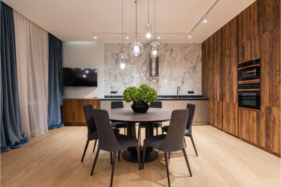 a circular dining table in the middle of a kitchen