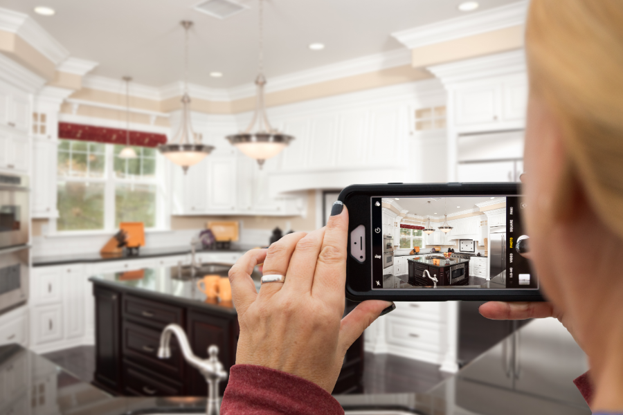 a real estate photographer taking a picture of a kitchen