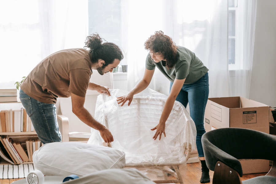 a man and woman packing items in a home