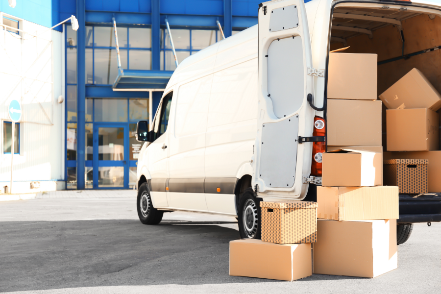 a moving van full of boxes outside a property