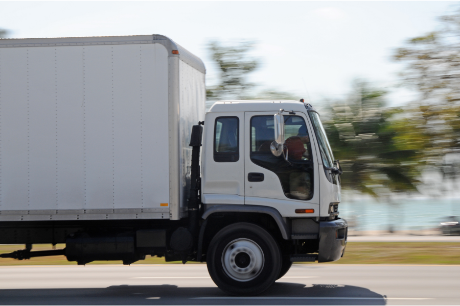 a moving van driving along a road