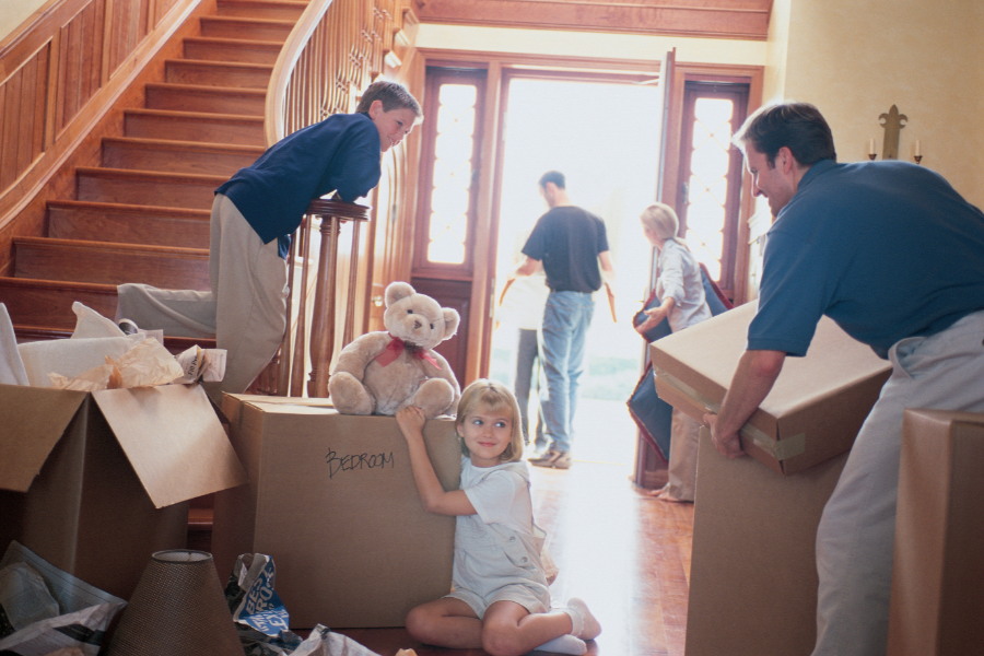 a family unloading boxes from a property and moving out