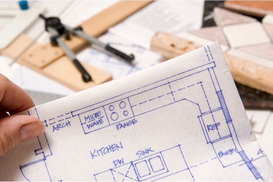 a set of remodeling plans on a workbench with tools