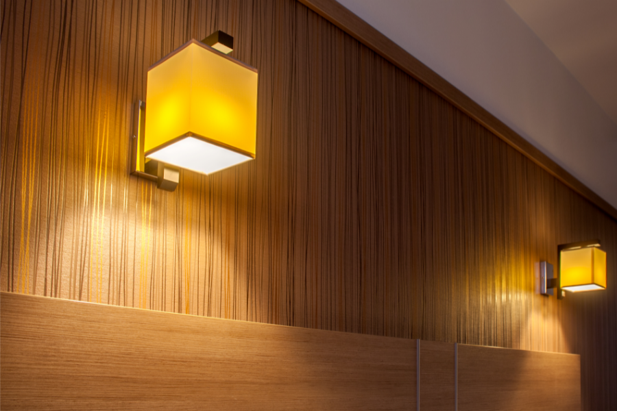 two wall lights above a bed in a bedroom