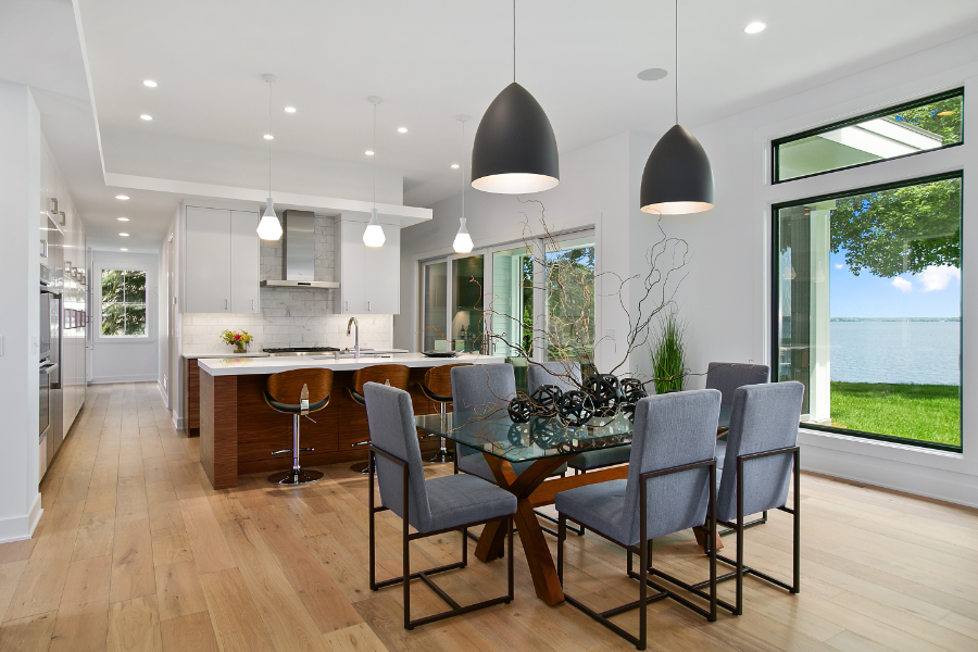 a kitchen dining room with pendant lights, hanging lights, and spotlights