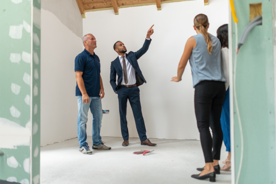 a real estate investor discussing renovations with a team