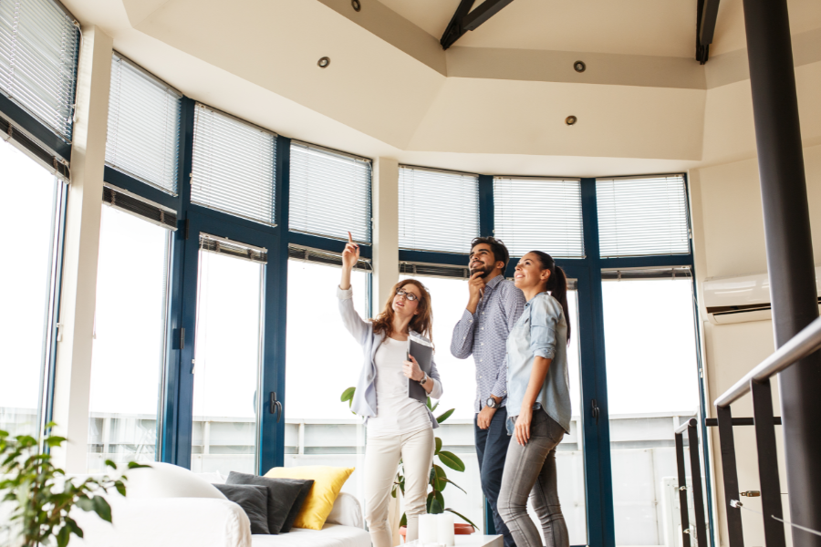 a couple viewing a property with a real estate agent