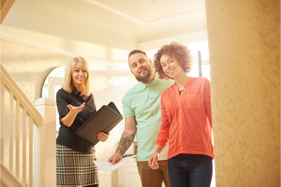 a real estate agent discussing a property with a man and woman