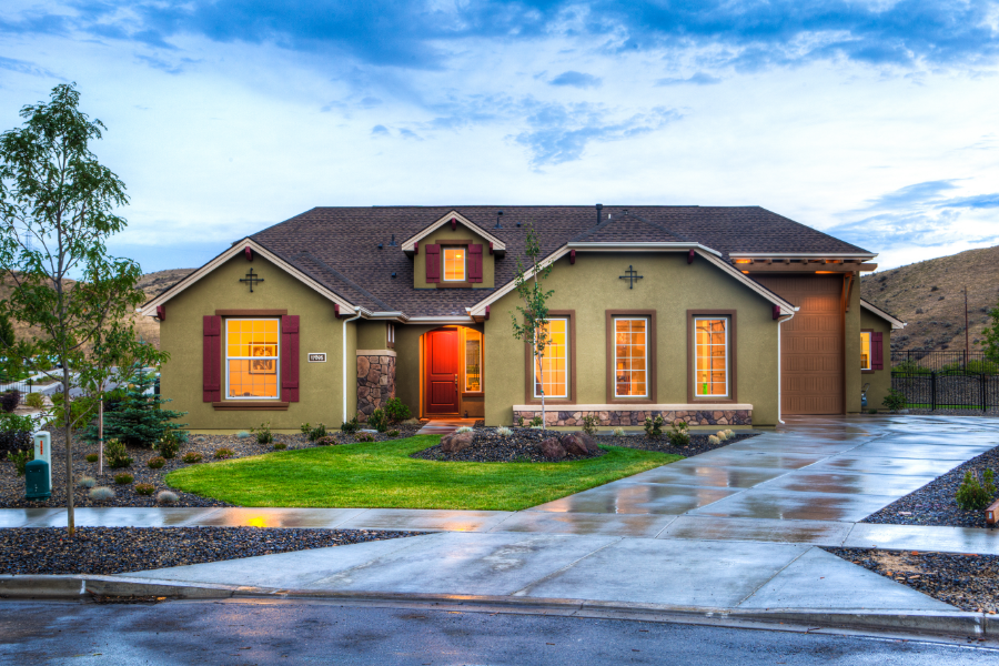 a property pictured from the outside with lights on inside